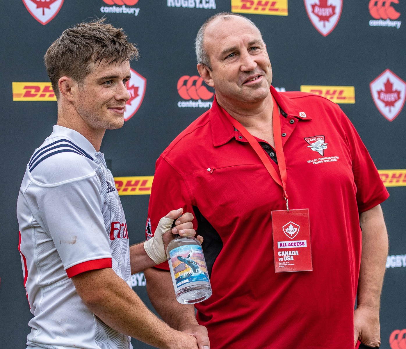 Al Charon presents AJ MacGinty with the Man of the Match Award after the USA beat Canada in Halifax, NS in 2018.
