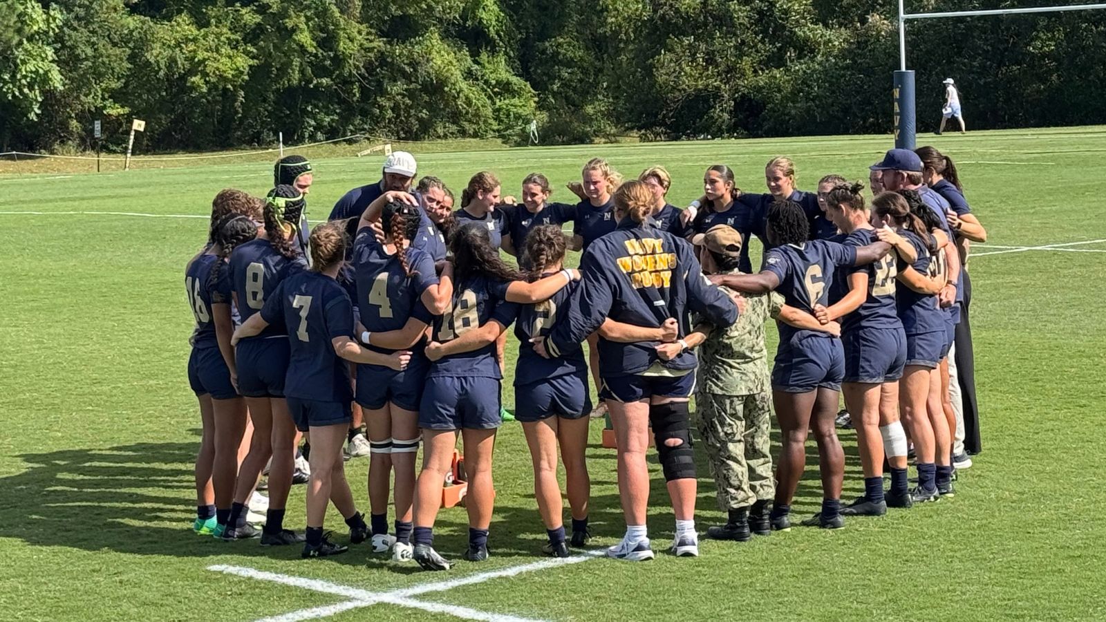 Navy women huddle up Fall 2026.