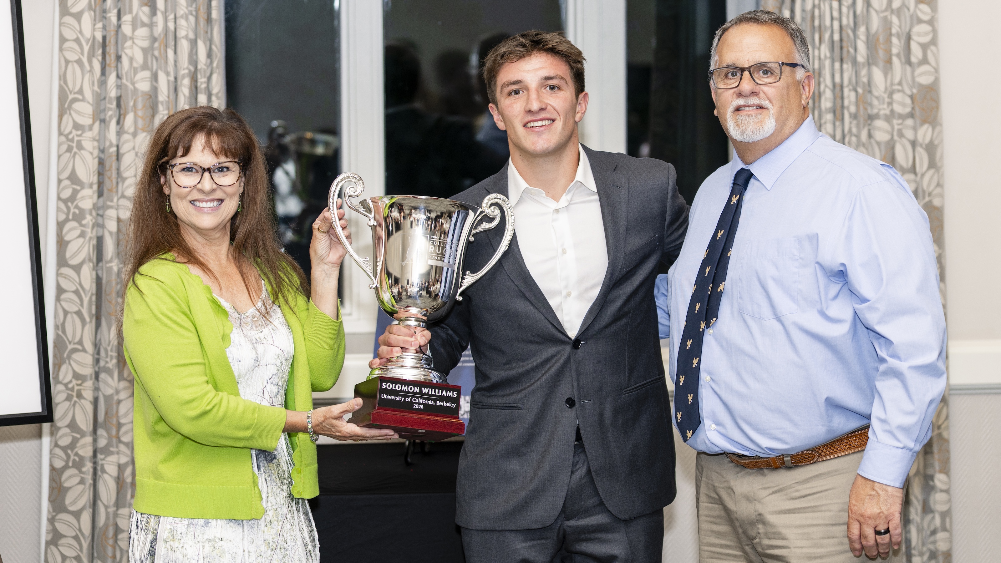 Solomon Williams receives his Rudy Scholz Award trophy from Rudy's granddaughter, Bonnie Puleo, and her husband, Michael. Photo Quinn Toomey for the WAC.