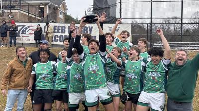 The Rebels celebrate their win.