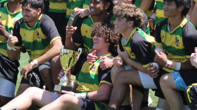 Sam Enochian with the Carmichael Hawks and their 2026 Northern California Gold championship trophy.
