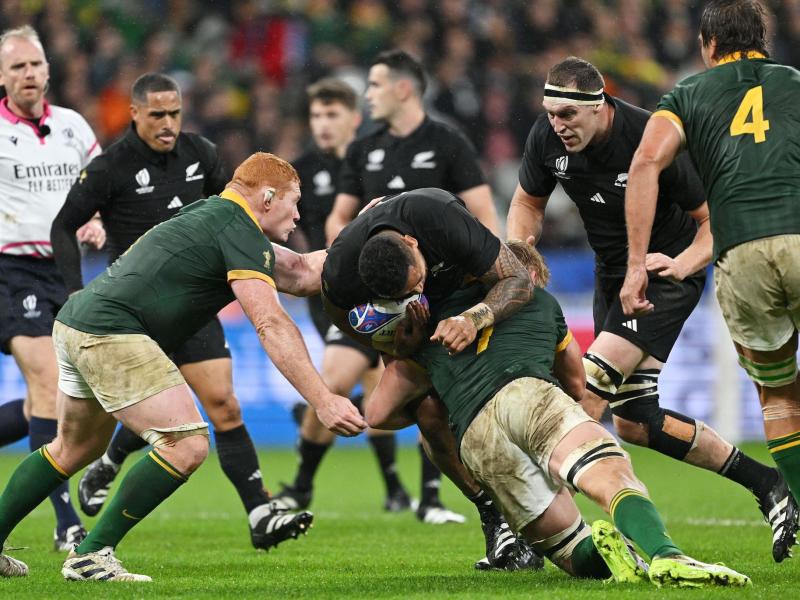 Shannon Frizell of New Zealand is tackled by Pieter-Steph Du Toit of South Africa during the 2023 Rugby World Cup Final at Stade de France Oct. 28, 2023. Photo by David Ramos - World Rugby/World Rugby via Getty Images.