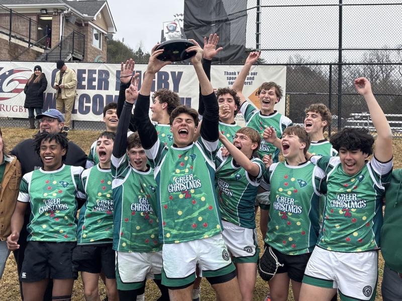 The Rebels celebrate their win.