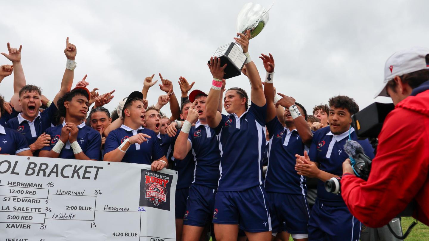 Charlotte Cardinals' Kemper Castro holds the Lee Kelly Trophy aloft. Photo Calder Cahill.