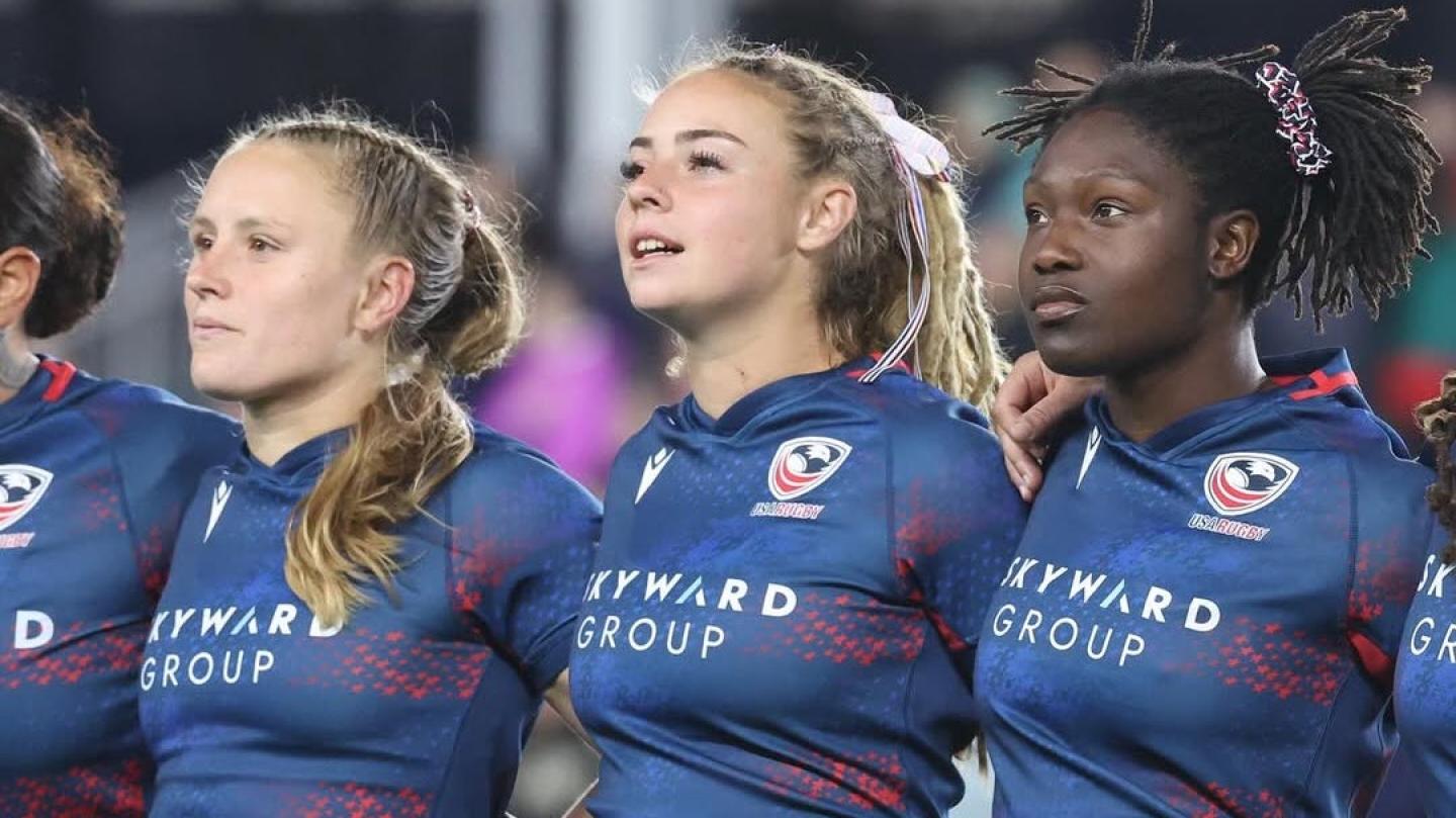 Cass Bargell, Bella Vogel, and Erica Coulibaly stand for the anthem.