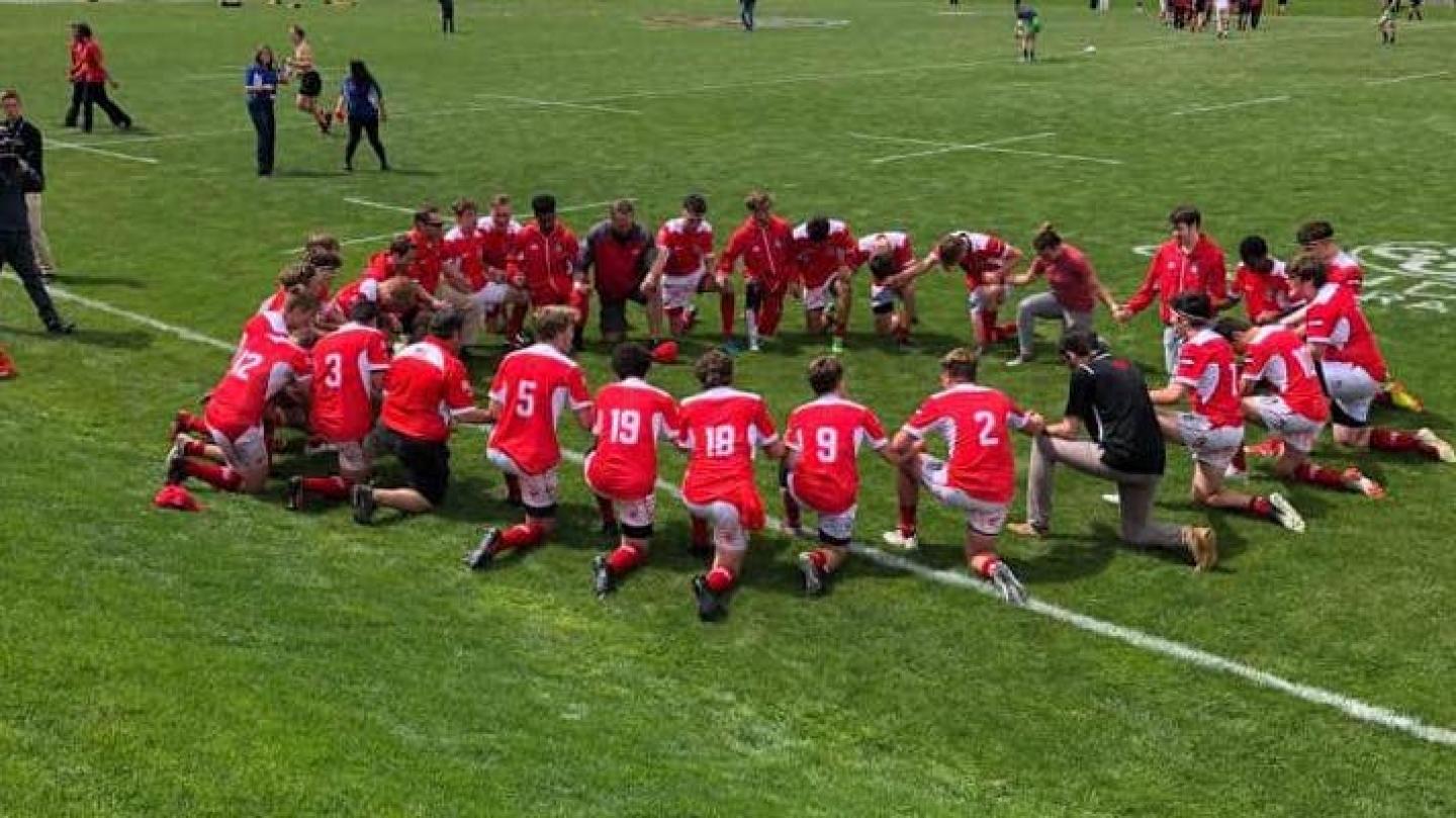 regis jesuit kneels